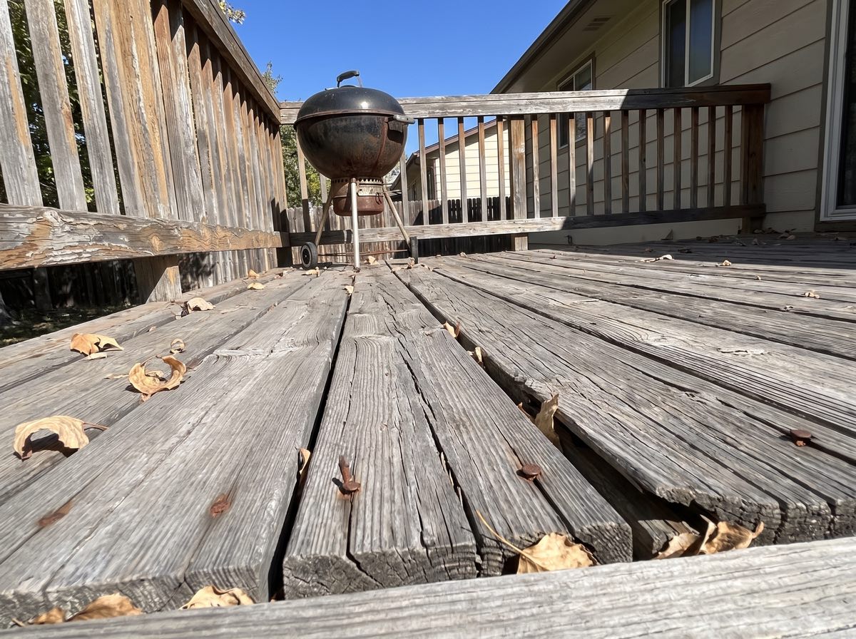 A splitting cedar deck in Berkeley the owner photographed in October. The homeowner called back in May, too late for June.